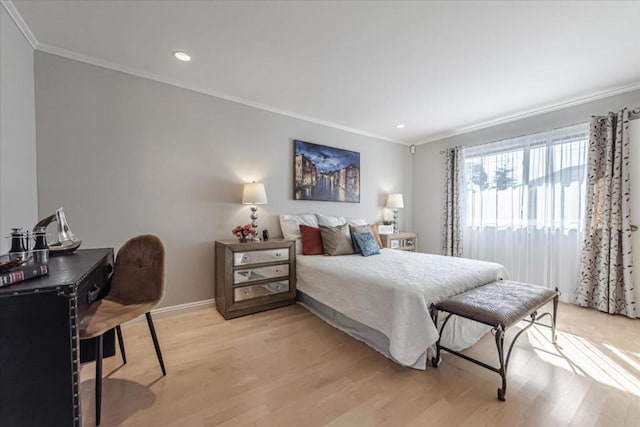 bedroom featuring crown molding and light hardwood / wood-style floors