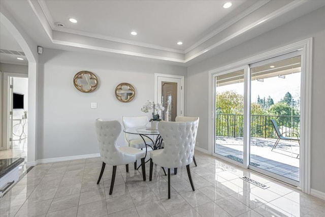 dining area featuring crown molding and a raised ceiling