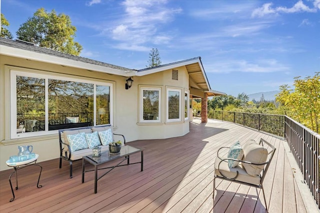 wooden terrace with outdoor lounge area