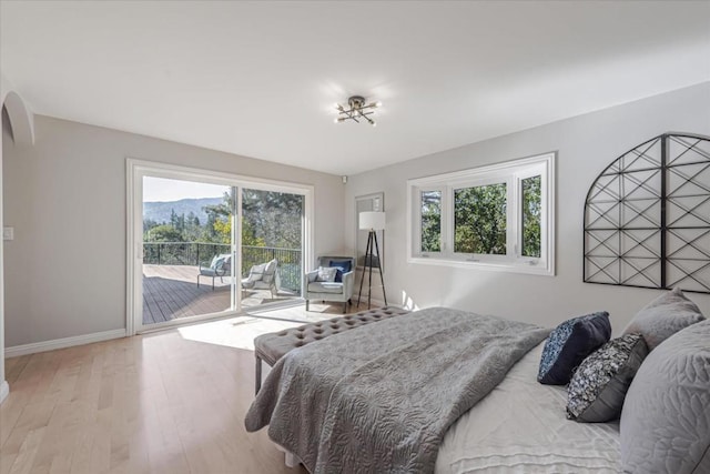 bedroom featuring light hardwood / wood-style flooring and access to outside