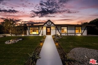 tudor-style house featuring a yard