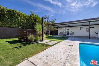 view of pool featuring a patio area and a lawn