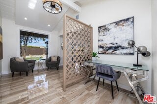 office featuring beamed ceiling, wood-type flooring, high vaulted ceiling, and a chandelier