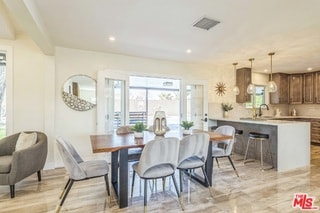 dining room with sink and a wealth of natural light