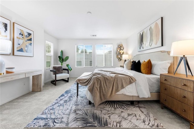 bedroom featuring light carpet