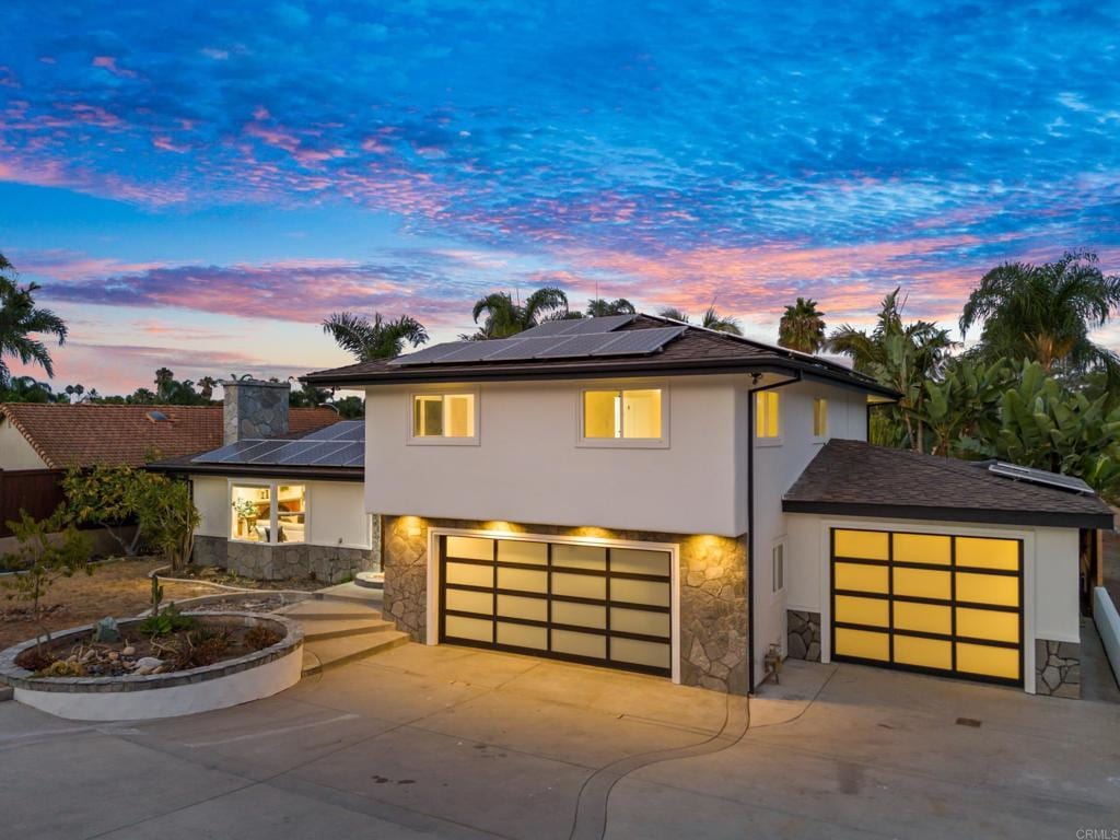 view of front of house with a garage and solar panels