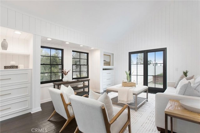 living room featuring vaulted ceiling and dark wood-type flooring