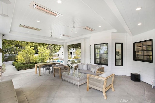 sunroom / solarium featuring ceiling fan