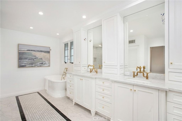 bathroom featuring vanity and a tub