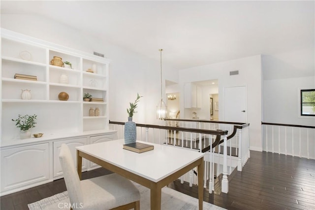 dining room featuring dark wood-type flooring and a notable chandelier