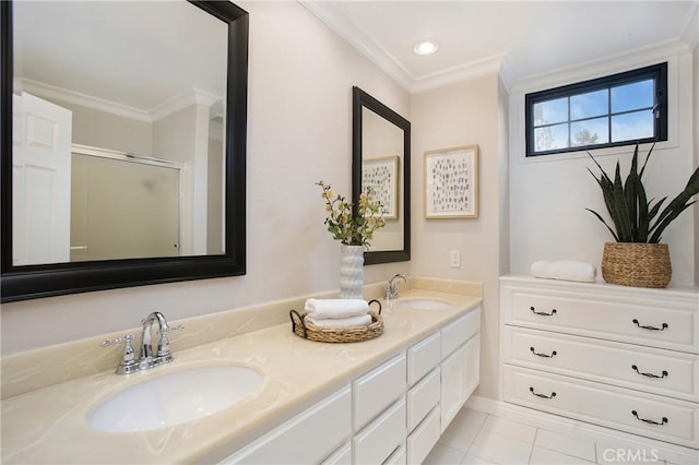 bathroom featuring tile patterned floors, ornamental molding, a shower with door, and vanity