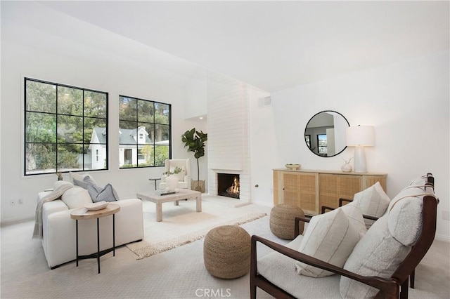 carpeted living room with a fireplace