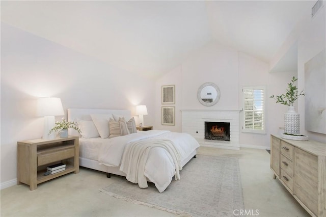 carpeted bedroom with high vaulted ceiling and a fireplace