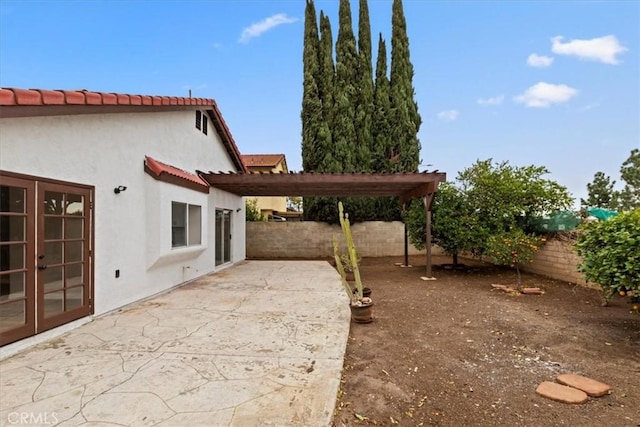 exterior space featuring a patio, a pergola, and french doors