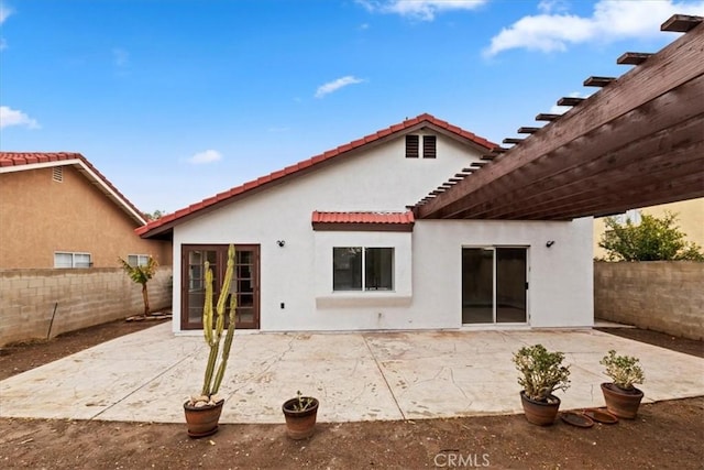 back of property featuring a pergola and a patio