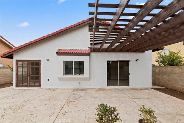 rear view of property with a pergola and a patio