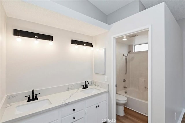 full bathroom with vanity, wood-type flooring, bathing tub / shower combination, and toilet