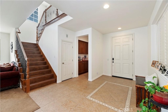 foyer entrance with light tile patterned floors