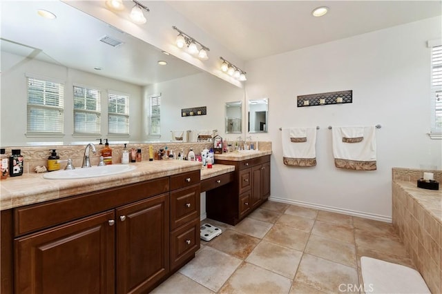 bathroom with vanity, tile patterned flooring, and backsplash