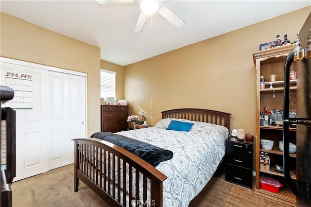 bedroom with ceiling fan, carpet flooring, and a closet