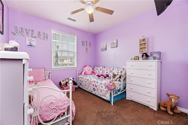 bedroom with ceiling fan and dark colored carpet