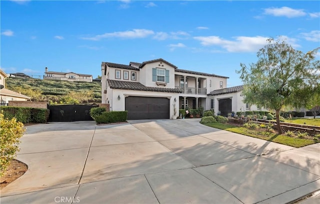 mediterranean / spanish-style house featuring a balcony and a garage