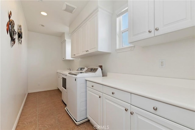 laundry room featuring separate washer and dryer, light tile patterned floors, and cabinets