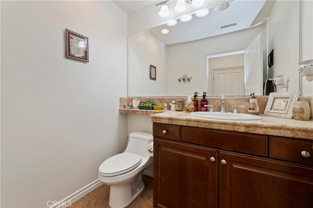 bathroom with tile patterned flooring, vanity, and toilet