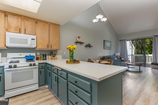 kitchen with white appliances, light hardwood / wood-style flooring, decorative light fixtures, and kitchen peninsula