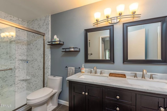 bathroom featuring vanity, a shower with shower door, tile patterned floors, and toilet