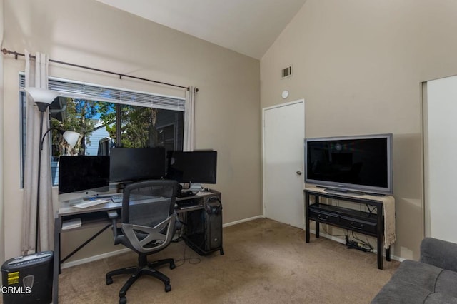 carpeted home office featuring vaulted ceiling