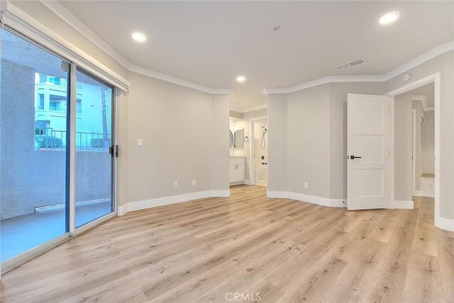 empty room featuring ornamental molding and light hardwood / wood-style floors