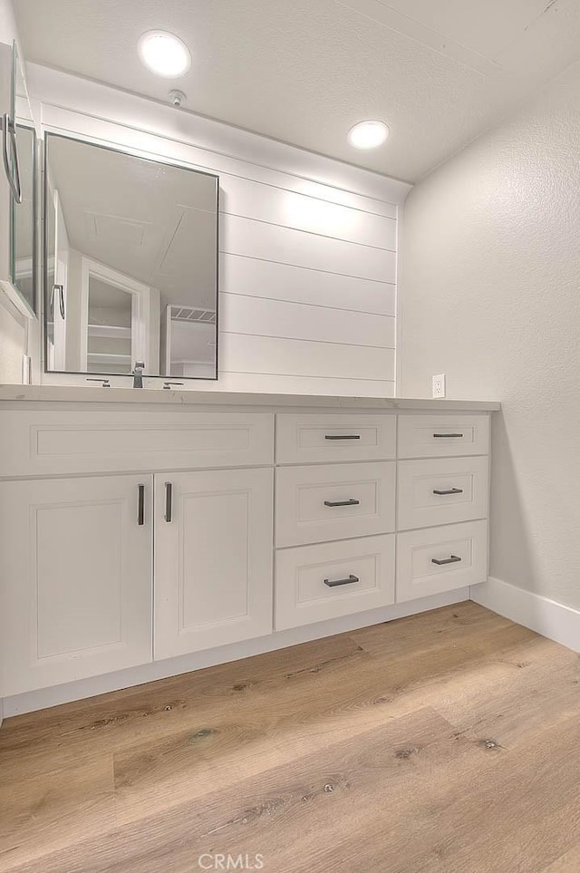 bathroom with vanity and hardwood / wood-style floors