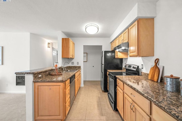 kitchen with sink, a breakfast bar area, dark stone countertops, kitchen peninsula, and stainless steel appliances