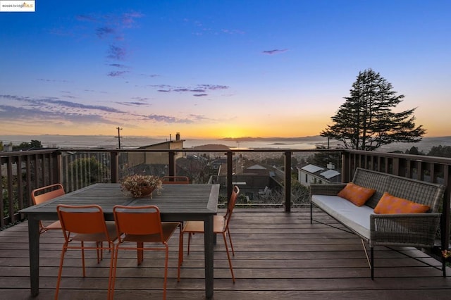 deck at dusk featuring an outdoor living space