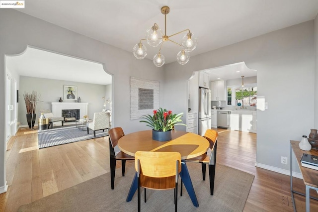 dining room with an inviting chandelier and light hardwood / wood-style floors