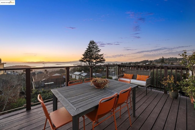 deck at dusk with an outdoor hangout area