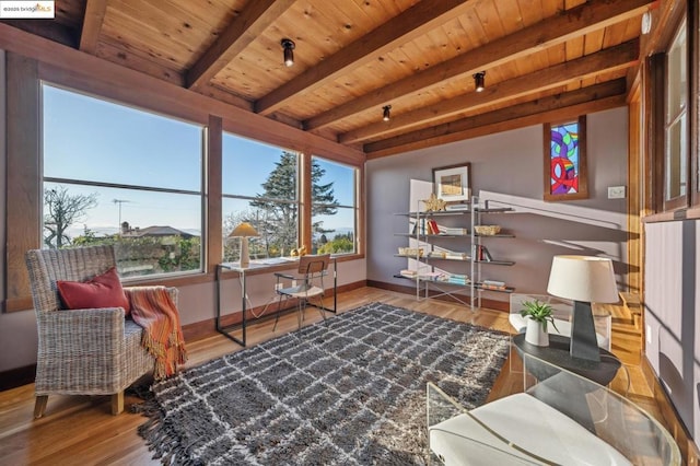 living area featuring beamed ceiling, wood ceiling, and wood-type flooring