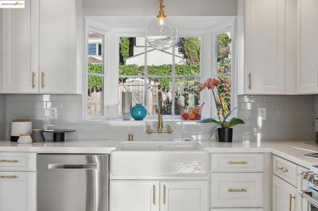 kitchen featuring white cabinetry, decorative backsplash, and appliances with stainless steel finishes