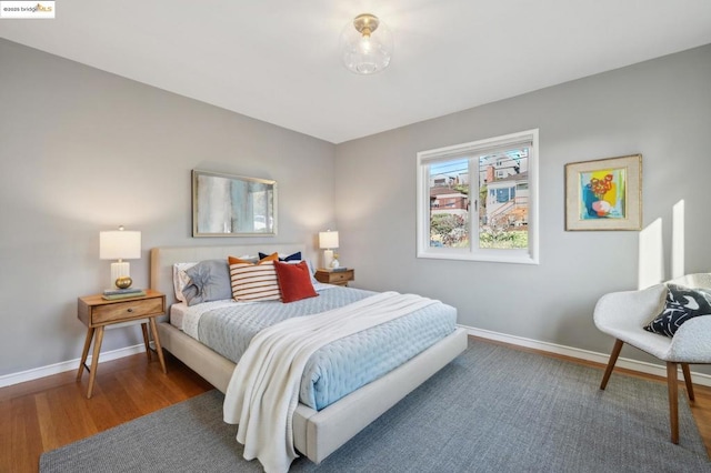 bedroom with dark wood-type flooring