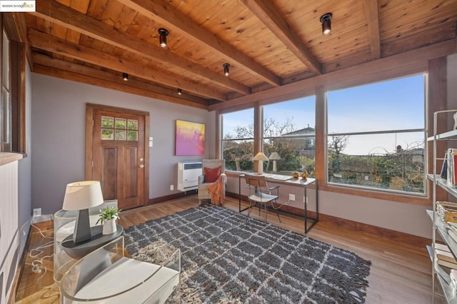 sunroom featuring heating unit, wood ceiling, and beam ceiling