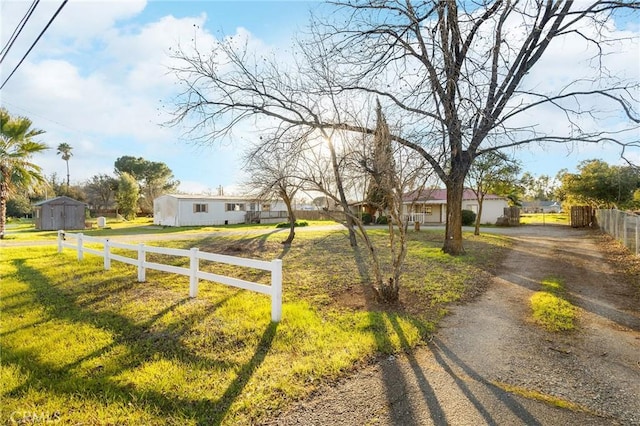 view of front of home with a shed and a front yard