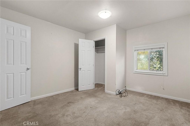 unfurnished bedroom featuring light carpet