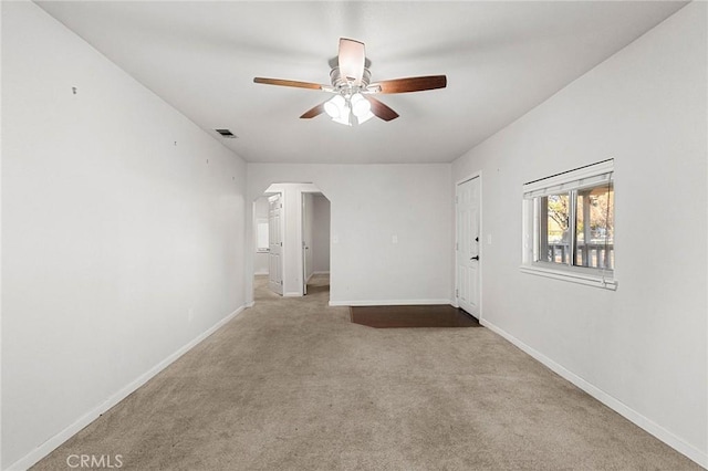 spare room with light carpet and ceiling fan