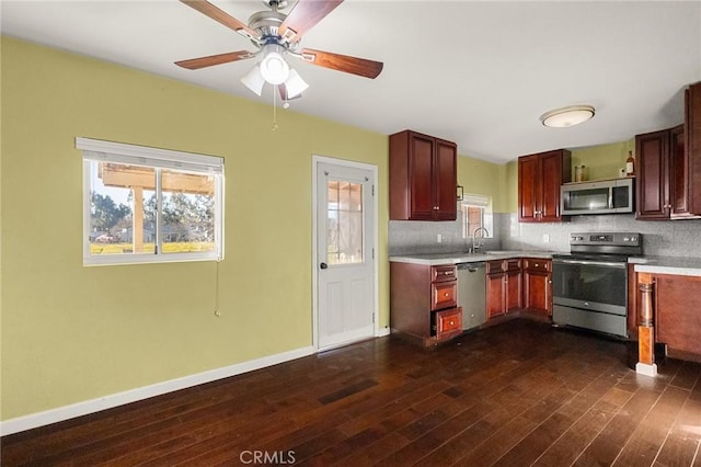 kitchen with dark hardwood / wood-style flooring, sink, decorative backsplash, and appliances with stainless steel finishes