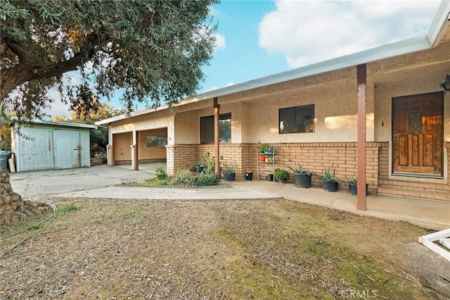 rear view of property featuring a shed