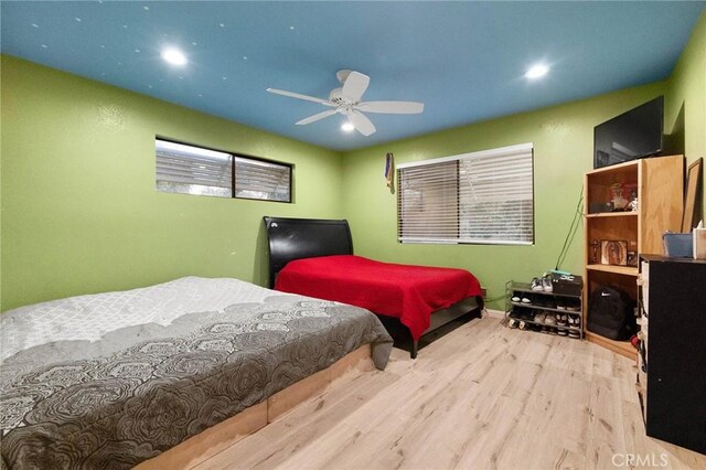 bedroom with light hardwood / wood-style floors and ceiling fan