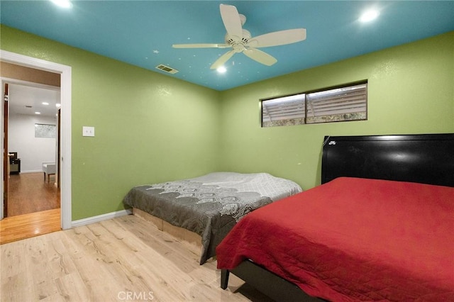 bedroom with ceiling fan and light wood-type flooring