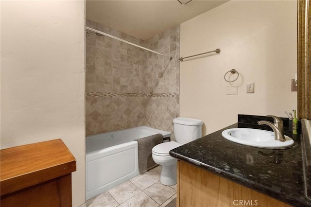 full bathroom featuring vanity, tiled shower / bath, tile patterned flooring, and toilet