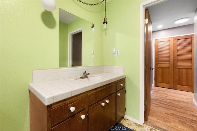 bathroom featuring hardwood / wood-style flooring and vanity